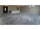 Large, unfinished living room with view of entry door and cement flooring at 18941 W Monterosa St, Litchfield Park, AZ 85340