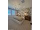 Stylish main bedroom with patterned wall, window and decorative chandelier at 18941 W Monterosa St, Litchfield Park, AZ 85340