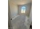 Unfinished room with a large arched window and concrete floors at 18941 W Monterosa St, Litchfield Park, AZ 85340