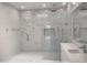 Sleek bathroom with a walk-in shower, marble walls, frameless glass and modern fixtures at 25150 N Windy Walk Dr # 14, Scottsdale, AZ 85255