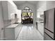 Modern kitchen featuring sleek white cabinets, stainless steel appliances, and large windows overlooking the yard at 25150 N Windy Walk Dr # 14, Scottsdale, AZ 85255