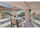 Inviting outdoor patio features a cozy fireplace, a pergola and string lights overlooking a sparkling pool at 25150 N Windy Walk Dr # 14, Scottsdale, AZ 85255