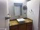 Bathroom showcasing a mirror, vanity sink, and granite countertop at 26243 W Wahalla Ln, Buckeye, AZ 85396