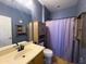 Cozy bathroom featuring a shower, vanity with a sink, wooden cabinet, and neutral color palette at 26243 W Wahalla Ln, Buckeye, AZ 85396