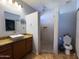 Elegant bathroom with shower, stylish granite sink and vessel sink at 26243 W Wahalla Ln, Buckeye, AZ 85396