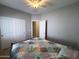 Comfortable bedroom features a ceiling fan, window with shutters, and closet at 26243 W Wahalla Ln, Buckeye, AZ 85396