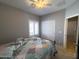 Comfortable bedroom features a ceiling fan, window with shutters, and closet at 26243 W Wahalla Ln, Buckeye, AZ 85396