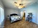 Bedroom featuring wood floors, ceiling fan and a view of the bathroom at 26243 W Wahalla Ln, Buckeye, AZ 85396