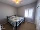 Comfortable bedroom features a ceiling fan, window with shutters, and closet at 26243 W Wahalla Ln, Buckeye, AZ 85396