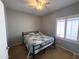 Cozy bedroom with neutral walls, ceiling fan, window with shutters, and carpet at 26243 W Wahalla Ln, Buckeye, AZ 85396