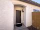 Inviting front entry with a neutral-colored exterior, a solid front door, and a covered porch area at 26243 W Wahalla Ln, Buckeye, AZ 85396