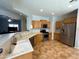 Bright kitchen features stainless steel appliances, wood cabinets, and tile flooring at 26243 W Wahalla Ln, Buckeye, AZ 85396