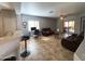 Spacious living room with an open layout, tile floors, and a sliding glass door to the patio at 26243 W Wahalla Ln, Buckeye, AZ 85396
