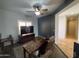 Comfortable living room with neutral paint, a ceiling fan, and views into the hallway and study at 26243 W Wahalla Ln, Buckeye, AZ 85396