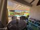 Inviting outdoor dining area on the patio with views of the backyard pool at 26243 W Wahalla Ln, Buckeye, AZ 85396