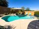 Backyard pool with seating and a shade umbrella at 26243 W Wahalla Ln, Buckeye, AZ 85396