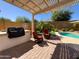 Relaxing pool area with comfortable seating and lush landscaping, perfect for entertaining at 26243 W Wahalla Ln, Buckeye, AZ 85396