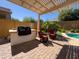 Beautiful backyard oasis featuring a pool, covered patio, and well-maintained landscaping at 26243 W Wahalla Ln, Buckeye, AZ 85396