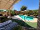 Stunning backyard pool area with lounge chairs, lush greenery, and a relaxing atmosphere at 26243 W Wahalla Ln, Buckeye, AZ 85396