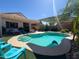 Sparkling blue pool with a built-in steps, lush landscaping, and inviting lounge chairs at 26243 W Wahalla Ln, Buckeye, AZ 85396