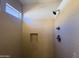 Modern tiled shower featuring a rainfall shower head and convenient in-wall niche at 26243 W Wahalla Ln, Buckeye, AZ 85396