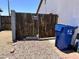 A wooden backyard gate is visible with a blue recycling container, complete with a 'Beware of Dog' sign at 2719 W Carter Dr, Tempe, AZ 85282