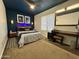 Inviting bedroom featuring carpet flooring, ensuite bathroom with a vanity, and modern ceiling fan at 2719 W Carter Dr, Tempe, AZ 85282