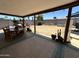 Shaded patio area with dining table, offering relaxing outdoor space and desert landscaping at 2719 W Carter Dr, Tempe, AZ 85282