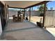 Spacious covered patio with outdoor dining set and views of the backyard and mature trees at 2719 W Carter Dr, Tempe, AZ 85282