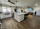 Open concept kitchen with a large island, stainless steel appliances, and white cabinets at 2719 W Carter Dr, Tempe, AZ 85282