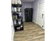 Well-lit pantry area with black refrigerator and white door, providing ample storage at 2719 W Carter Dr, Tempe, AZ 85282