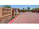 Community entrance at The Pinnacle at Desert Peak with monument sign, landscaping, and red brick paving at 2725 E Mine Creek Rd # 2146, Phoenix, AZ 85024