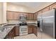 Kitchen featuring stainless steel appliances, granite counters, and dark wood cabinetry at 2725 E Mine Creek Rd # 2146, Phoenix, AZ 85024