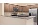 Kitchen featuring granite counters, stainless steel appliances, and dark wood cabinets at 2725 E Mine Creek Rd # 2146, Phoenix, AZ 85024