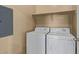 A laundry room with a shelf and white washer and dryer at 2725 E Mine Creek Rd # 2146, Phoenix, AZ 85024