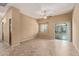 Neutral living room with a ceiling fan, window, and sliding glass door to a covered balcony at 2725 E Mine Creek Rd # 2146, Phoenix, AZ 85024