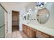 Bathroom with dual sinks, spacious vanity, and a separate glass-enclosed shower at 2729 N Kenton St, Mesa, AZ 85215