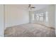 Bedroom showcasing a large window for natural light and neutral carpet flooring at 2729 N Kenton St, Mesa, AZ 85215