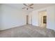 Bedroom featuring neutral carpet, a ceiling fan, and a view into an adjacent hallway and closet at 2729 N Kenton St, Mesa, AZ 85215