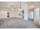 Open-concept living room features neutral carpet, high ceilings, and a fan for added comfort at 2729 N Kenton St, Mesa, AZ 85215