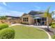 Beautiful backyard featuring a putting green, patio area, and lush landscaping at 3058 E Spring Wheat Ln, Gilbert, AZ 85296