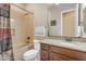 Well-maintained bathroom with granite countertop, shower-tub combo, and coordinated fixtures at 3058 E Spring Wheat Ln, Gilbert, AZ 85296