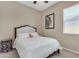 Cozy bedroom with neutral tones, a comfortable bed, and natural light from the window at 3058 E Spring Wheat Ln, Gilbert, AZ 85296