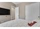 Relaxing bedroom with a TV, soft patterned bedding, and closet for storage at 3058 E Spring Wheat Ln, Gilbert, AZ 85296