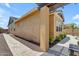 Exterior side view of a home with a paver walkway and manicured landscaping at 3058 E Spring Wheat Ln, Gilbert, AZ 85296