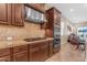 Modern kitchen featuring granite countertops, a stainless steel range hood, and built-in microwave and oven at 3058 E Spring Wheat Ln, Gilbert, AZ 85296
