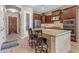 Elegant kitchen featuring granite countertops, dark wood cabinetry, stainless steel appliances and counter seating at 3058 E Spring Wheat Ln, Gilbert, AZ 85296