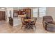 Cozy kitchen with dark wood cabinets, granite countertops, and a dining area at 3058 E Spring Wheat Ln, Gilbert, AZ 85296