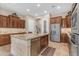 Well-appointed kitchen featuring granite countertops, a large island, stainless steel appliances, and custom cabinetry at 3058 E Spring Wheat Ln, Gilbert, AZ 85296