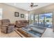 Inviting living room with a ceiling fan and access to an outdoor patio area at 3058 E Spring Wheat Ln, Gilbert, AZ 85296